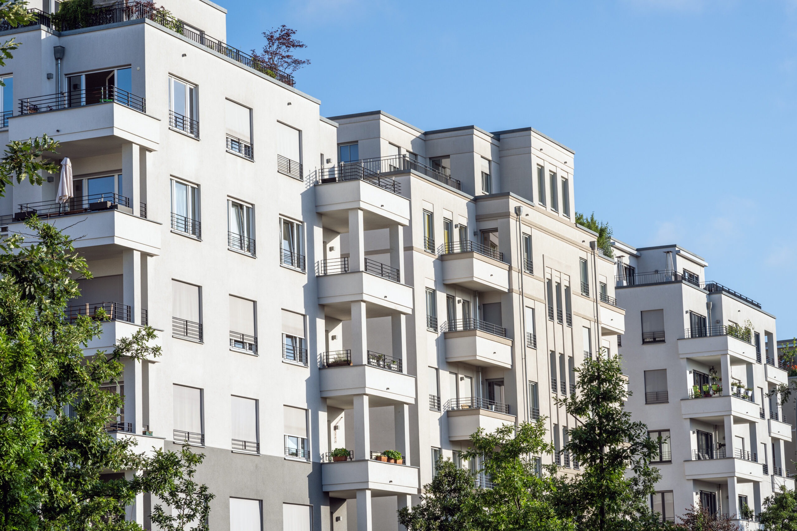 white-apartment-building-with-trees-2025-03-08-20-36-33-utc (1)